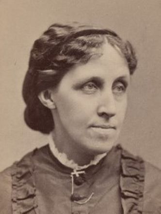 An old photo of a woman in a dress.