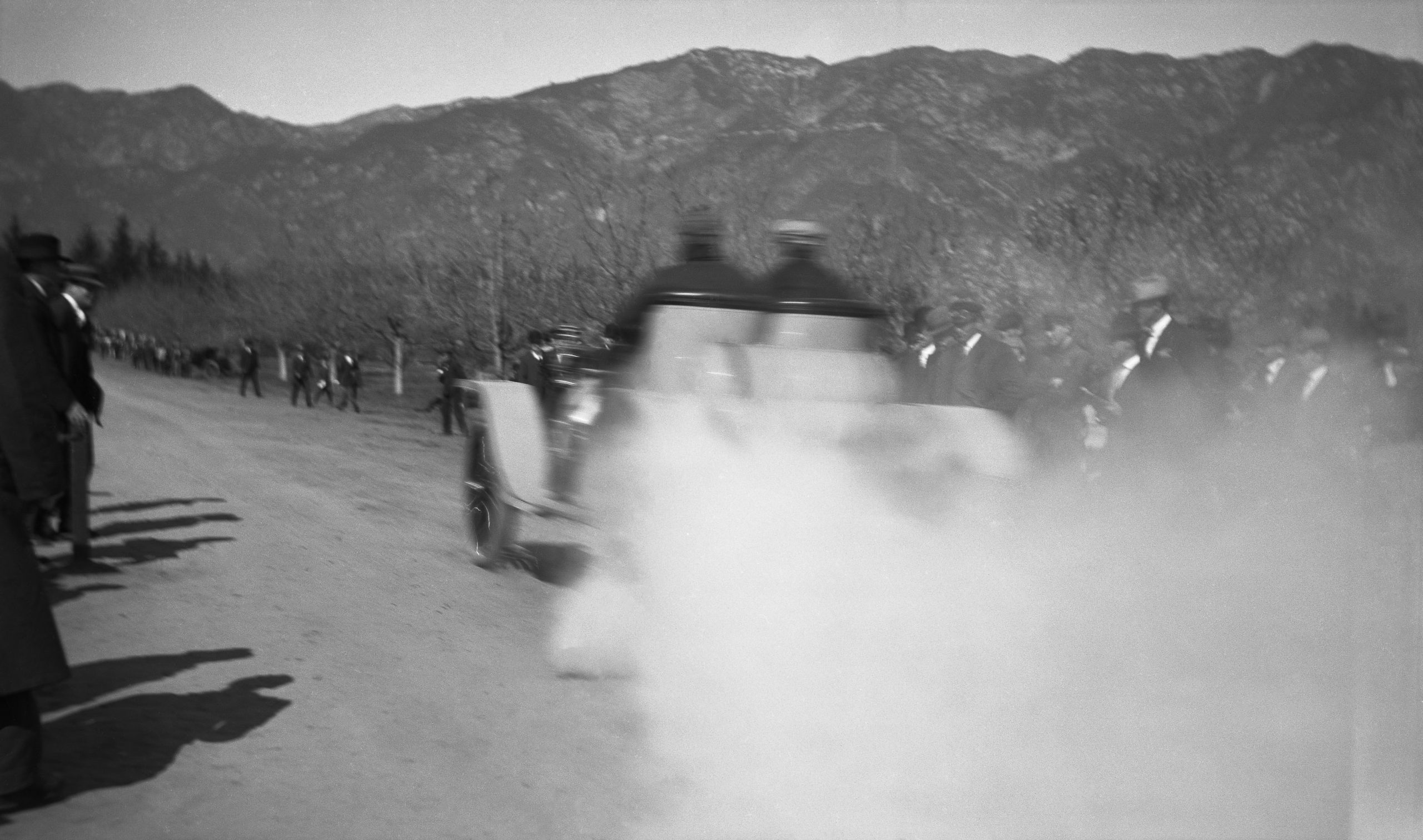 vintage photo of two men racing an automobile