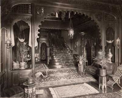 The staircase in the Middle Hall led to the Algerian Court. The peacock’s tail feathers can be seen center top. Circa 1897 (PHS1-21).