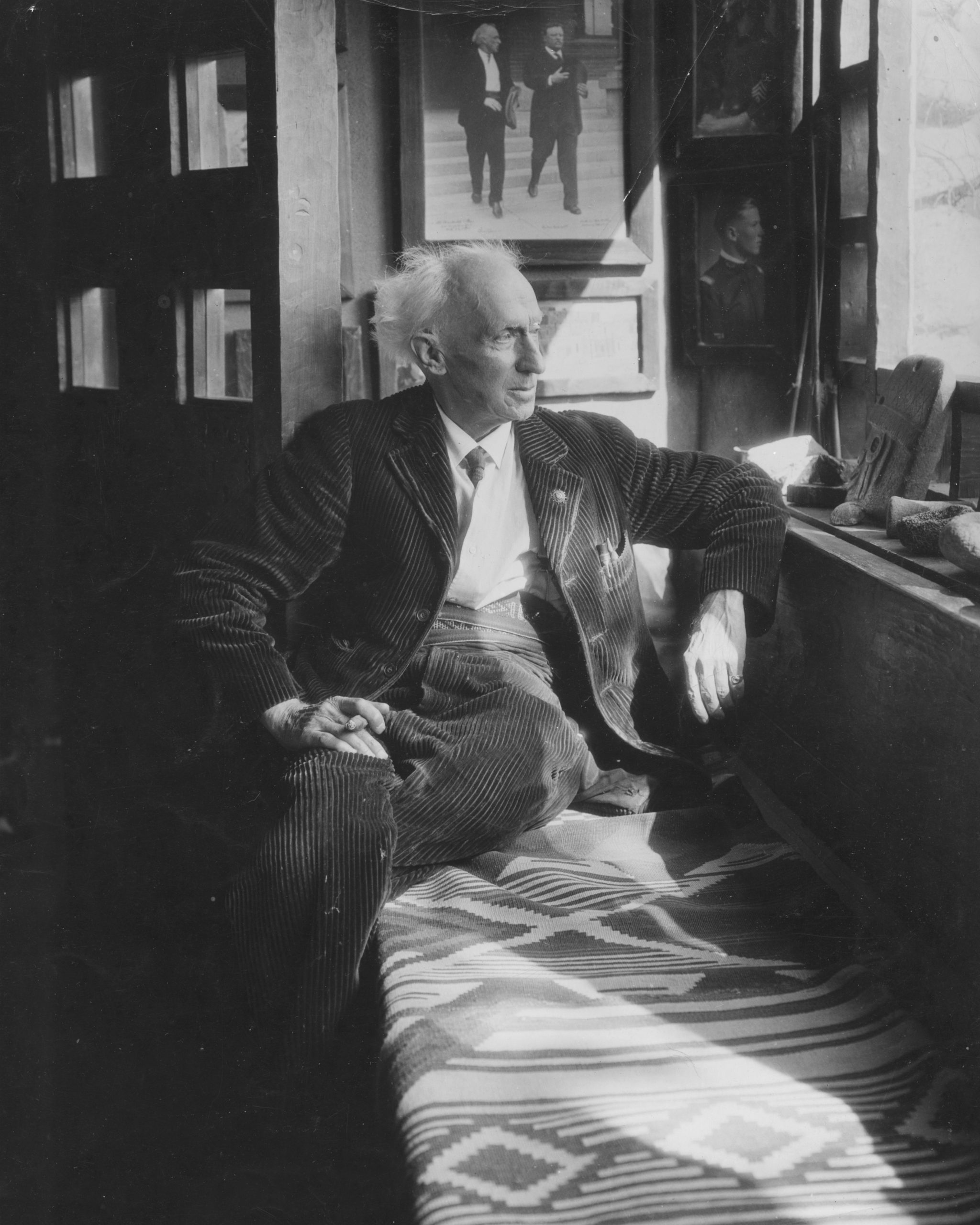Charles Lummis Sitting on a bench at El Alisal